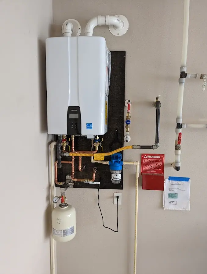 Professional plumber installing copper piping in a Trappe home